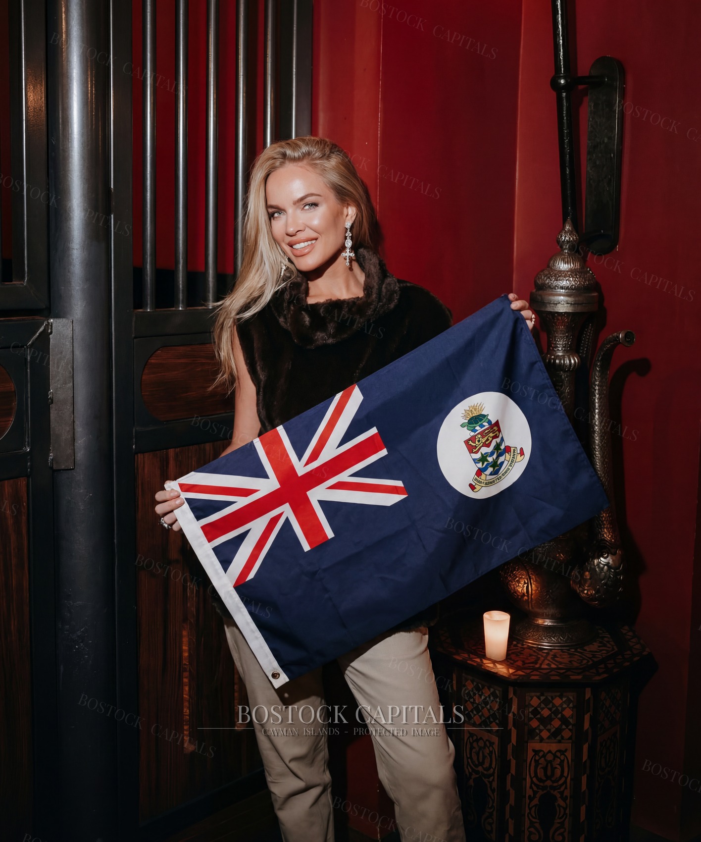 Scarlett Bostock with the flag of the Cayman Islands